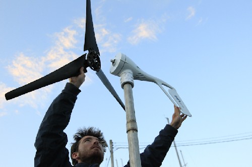 Putting the blades on the mounted Air Breeze wind turbine!