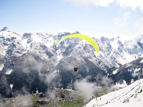 Jess paragliding over the Austrian Alps - Click for full-size.
