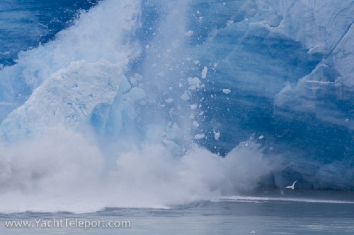 Surge wave erupting as ice falls from glacier - Click for full-size.