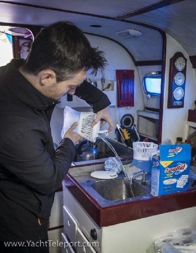 Chris pouring out the water collected by one of the DampRid containers